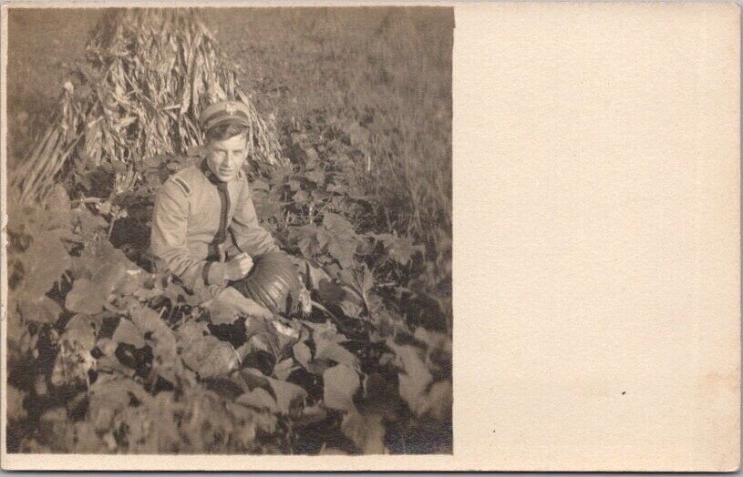 c1910s Real Photo RPPC Postcard Young Man in Military Uniform / Pumpkin Patch