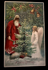 Red Robe~Santa Claus Cuts Xmas Tree ~with Angel-Antique~Christmas Postcard~k382 picture