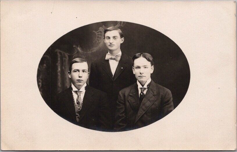 c1910s McCRACKEN, Kansas RPPC Real Photo Postcard Three Young Men in Suits
