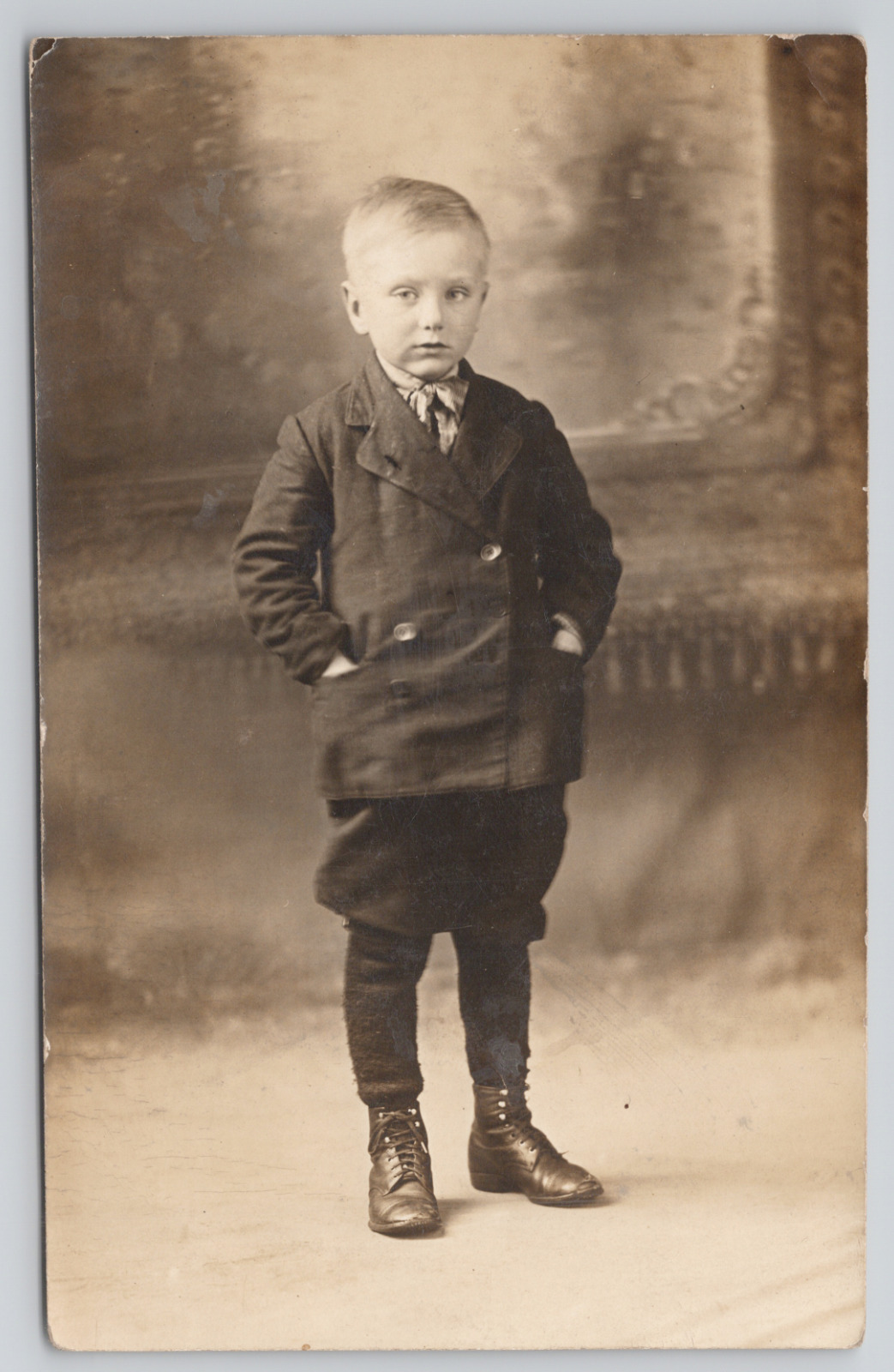 Real Photo Postcard Little Boy in Studio with Hands in Jacket Pocket c1910 RPPC