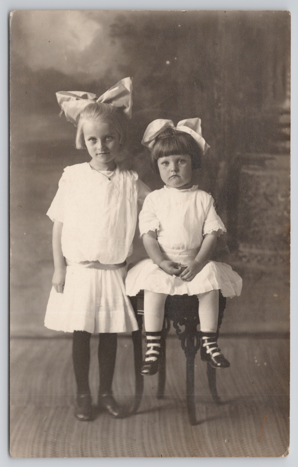 Real Photo Postcard Little Girls in Big Bows Wearing White in Studio c1910 RPPC