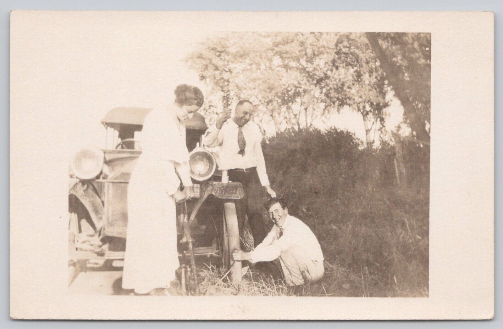 RPPC Postcard Men Changing Tire On Vintage Car Woman Helping Lift Car Real Photo