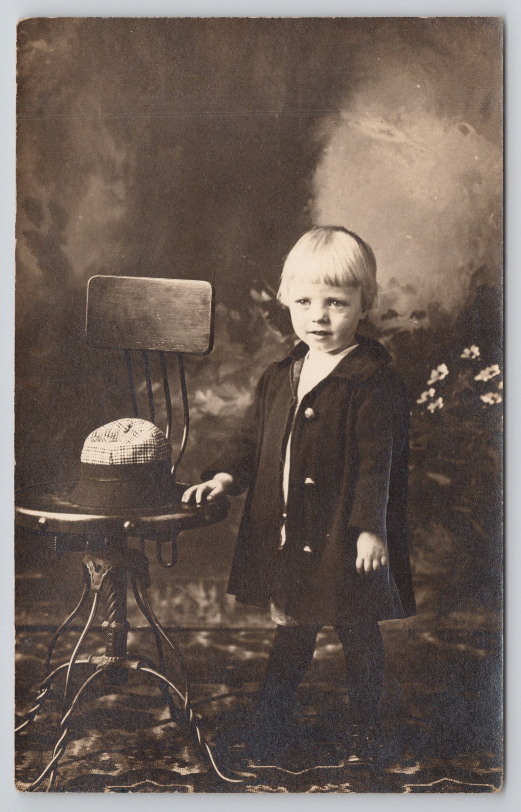 Real Photo Postcard Blonde Haired Child in Studio Beside Chair & Hat c1910 RPPC